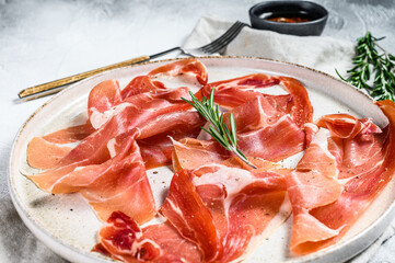 prosciutto crudo, italian salami, parma ham. Antipasto plate. Gray background, top view.