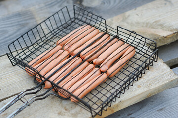 a lot of sausages lying on the grill