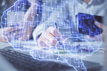 Double exposure of man and woman working together and brain drawing hologram. Intellectual brainstorming concept. Computer background.