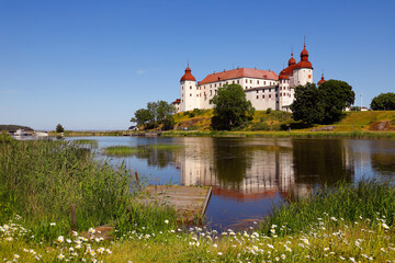 Fototapeta na wymiar Summer at the medieval Lacko castle located in Swedish province of Vastergotland.