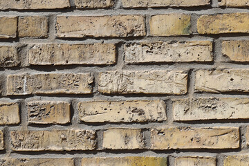 Close-up of an yellow old brick wall