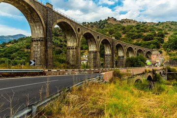 An abandoned railway bridge close to the Alcantara river near Taormina, Sicily in summer