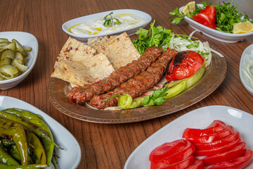 Turkish Adana Kebab Dinner on wooden background.