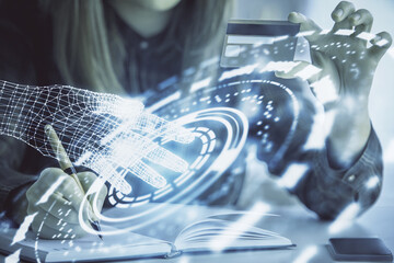 Double exposure of woman on-line shopping holding a credit card and data theme hologram drawing. E-commerce concept.
