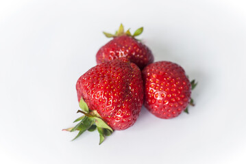 Eco or Bio Strawberry on White Background - Three Berries Inverted Composition Isolated Close up View Shot with Natural Light