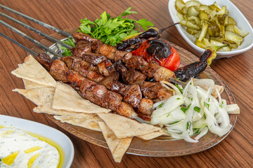 Turkish liver skewers on wooden background.