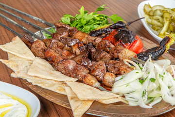 Turkish liver skewers on wooden background.
