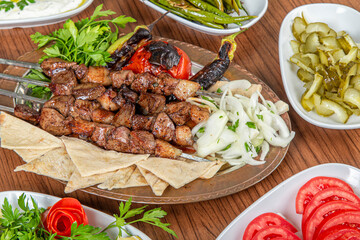 Turkish liver skewers on wooden background.