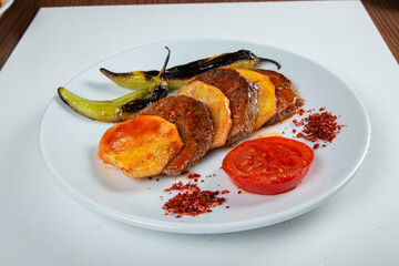 Turkish roast meat dumplings on wooden background.