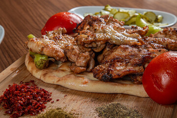 Turkish chicken butterfly on a wooden background.