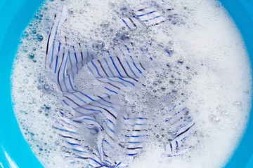 Clothes soak in powder detergent water dissolution.