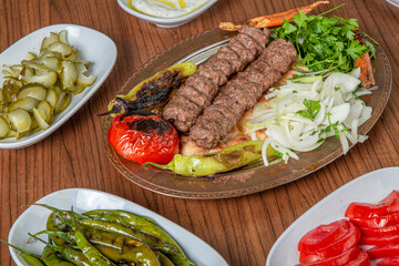 Turkish Urfa Kebab Skewer Dinner on Wooden Background