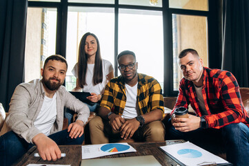 Group portrait of young ambitious startupers. A successful business team gathered in its modern office in a friendly atmosphere to develop a new ideas and startups