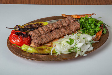 Turkish Urfa Kebab Skewer Dinner on Wooden Background