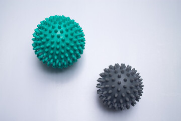 Two green and gray massage balls.