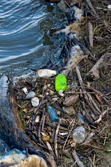 Floating old garbage in water, plastic bottles