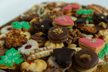 Some of Christmas cookies stored on a gold bowl of candy of different kinds of colors and shapes...