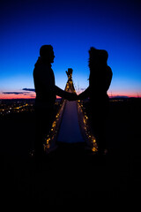 Love couple holding with teepee during dark sunset © Cavan
