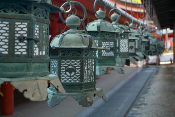 Buddhist temple green lanterns row at Kasuga-Taisha Shrine in Nara Japan