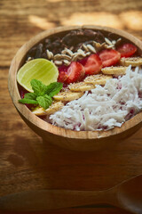 Close up fruit bowl in wooden plate on the rustic table