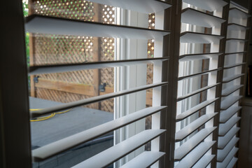 close up of an open window with shutters during sunny weather	