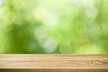 Empty table top green bokeh  background.