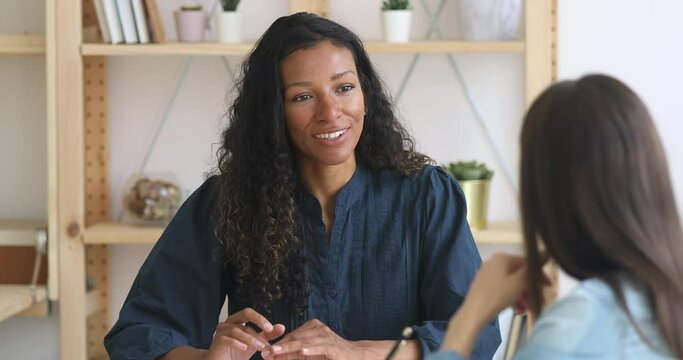Happy smiling african american businesswoman sales manager or job applicant speaking to hr client colleague customer at business office meeting job interview make good first impression sell services