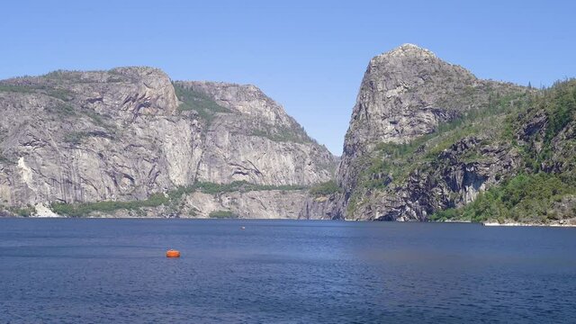 The manmade Hetch Hetchy Reservoir in Yosemite National Park provides water to city of San Francisco through gravity fed pipe system spans California vast central valley. sunny day with blue sky.