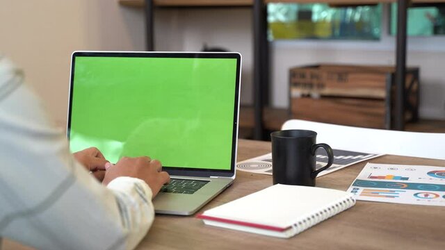 Office users using a laptop computer with a laptop green screen