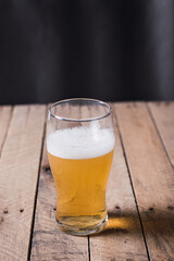 glass of beer on wooden table