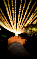 hand reaching out lights