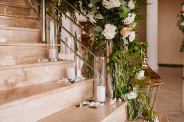 Fototapeta na wymiar Beautiful luxury wedding reception with flowers. Stairs decorated with flowers