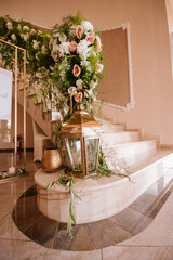 Beautiful luxury wedding reception with flowers. Stairs decorated with flowers