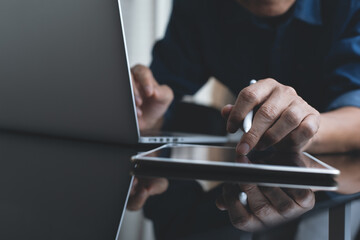 close up of casual business man online working on laptop computer at home office