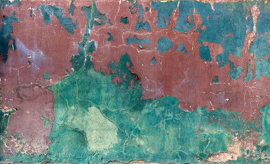 blue, red and green grunge cracked wall with peeling paint and chipped - rough texture for a background wallpaper
