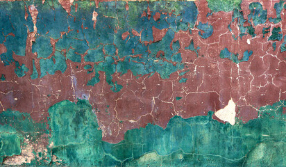 blue, red and green grunge wall with peeling paint and chipped - rough texture for a background wallpaper