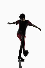 Fototapeta na wymiar A soccer player kicking a soccer ball