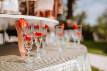 Glasses of champagne with strawberry on top in the restaurant