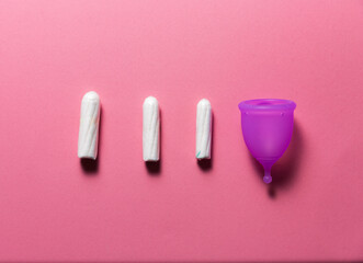 Feminine hygiene products on bright pink background