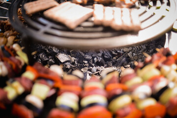 The chef grills meat and vegetables in the backyard