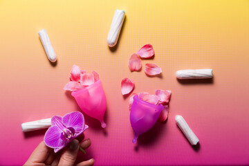 Feminine hygiene products on bright pink background