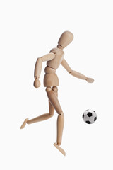 Wooden dummy model playing soccer