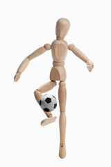 Wooden dummy model playing soccer