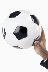 Soccer manager holding a ball with one hand