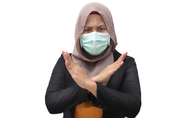 Asian muslim businesswoman wearing hijab and medica face mask shows stop hand sign gesture. Stop corona covid disase concept