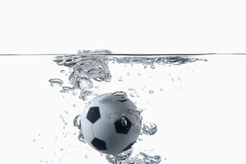 Naklejka premium Soccer ball splashing into water