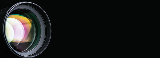 Banner. The camera lens. Close-up of the camera lens on a black background, on the right there is an empty space for the text. Optics.