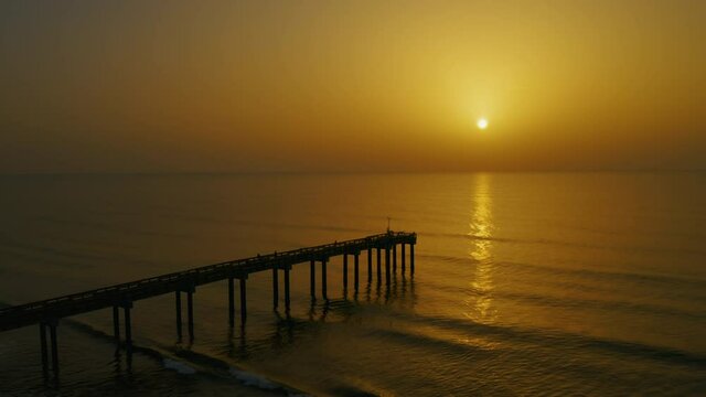 Saharan dust sunrise at the Saint Augustine Beach pier on Florida's east coast.