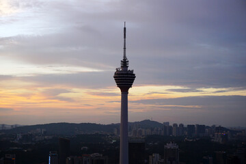Naklejka premium Skyline of KL tower and skyscrapers during sunset 