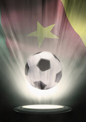 A soccer ball with Cameroon flag backdrop